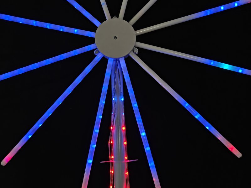 Commercial outdoor firework light at shopping mall entrance at night